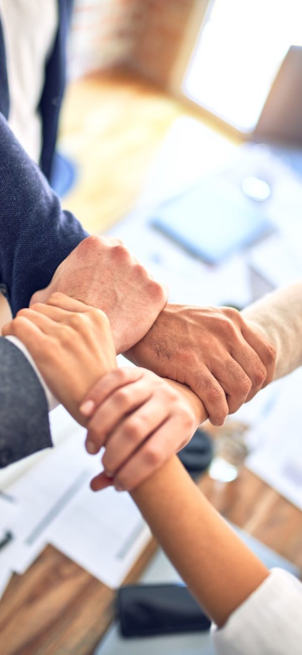 person in black long sleeve shirt holding persons hand